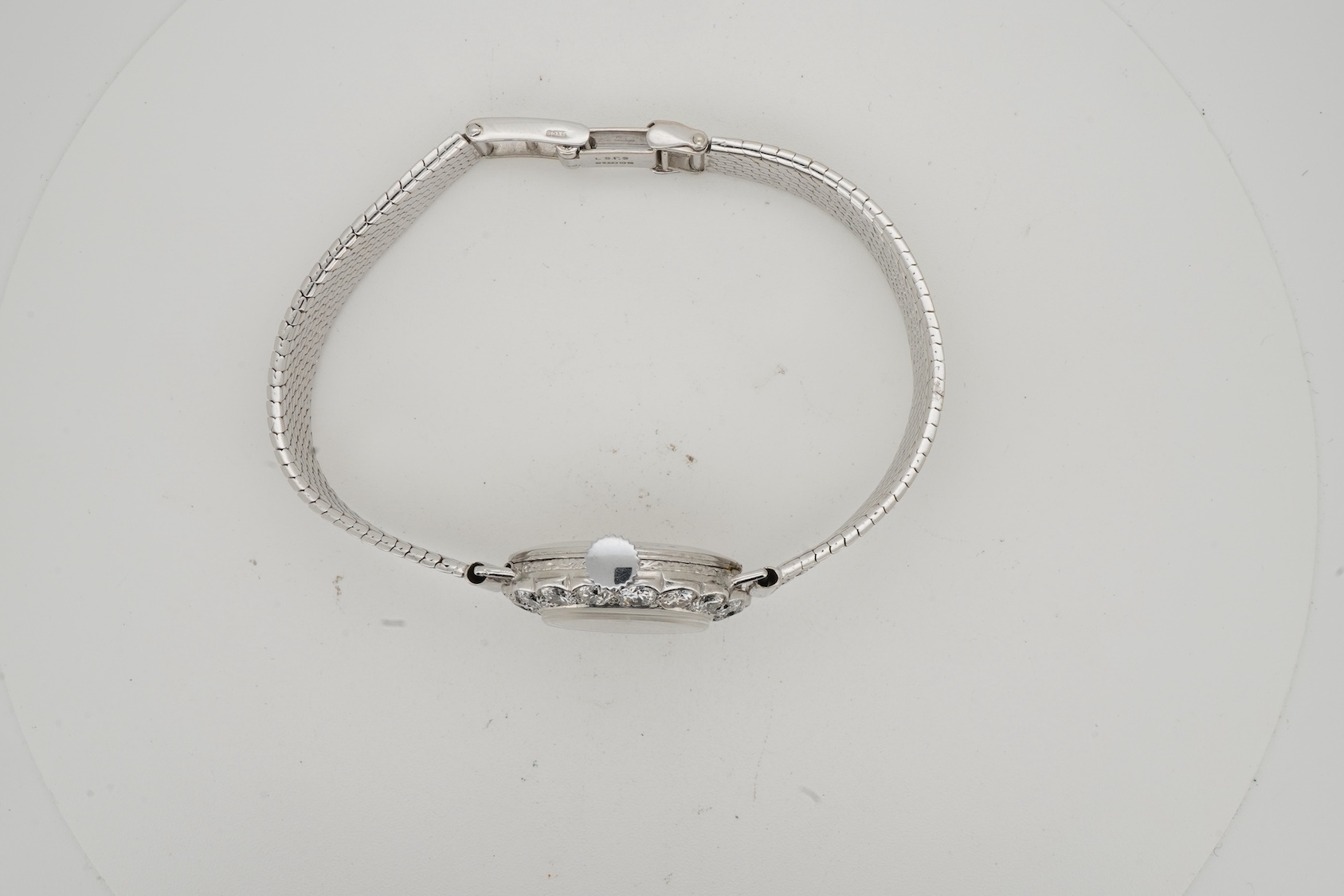 A lady's early 1940's platinum and diamond set manual wind cocktail watch, on a 9ct white gold mesh link bracelet